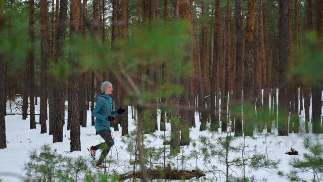 athlete dressed sportswear sprinting fast exercising cardio workout in winter woman running in forest athlete training for marathon competition