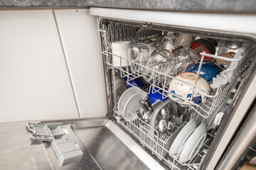 Woman use dishwasher machine for housework
