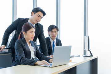 A group of young Asian businessmen Talking and planning work happily and have fun. at the company's office