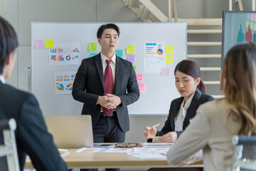 A group of young Asian businessmen Talking and planning work happily and have fun. at the company's office