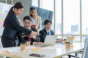 A group of young Asian businessmen Talking and planning work happily and have fun. at the company's office
