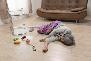 Senior woman is falling because hypertension in living room.