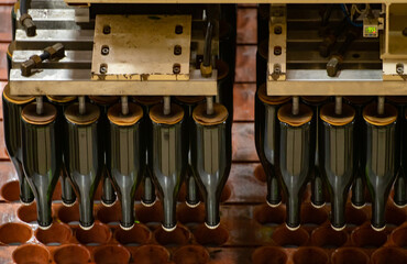 Production of cremant sparkling wine in Burgundy, France. Automatically powered bottling and riddling lines on factory.