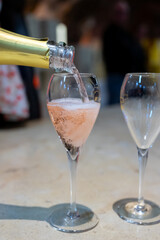 Tasting of rose champagne sparkling wine produced by traditional method in underground caves in Champagne, France