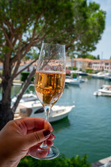 Summer party, drinking of French brut champagne sparkling wine in glasses in yacht harbour of Port Grimaud near Saint-Tropez, French Riviera vacation, France