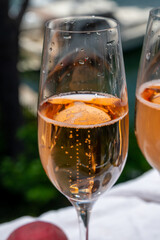 Summer party, drinking of French brut champagne sparkling wine in glasses in yacht harbour of Port Grimaud near Saint-Tropez, French Riviera vacation, France