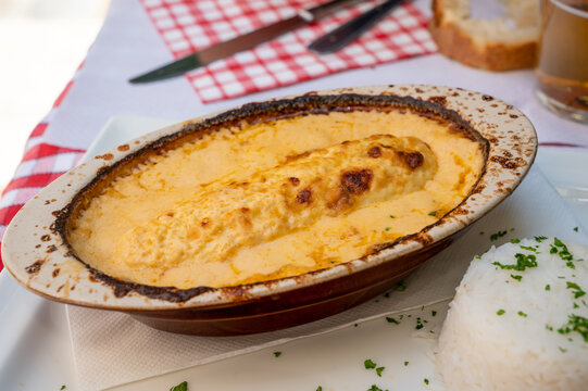 Quenelle, speciality of Lyon, oval-shaped dumplings filled with pike white fish served in creamy sauce in traditional Lyonnaise Bouchon, France