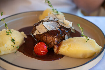 Beefsteak served with fresh black truffle mushroom and balls of mashed potato in French restaurant
