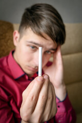 Young Man looking at a Cigarette