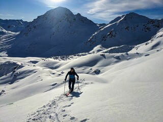 Fototapeta na wymiar Ski tour above davos. Beautiful trail in deep snow surrounded by snowy mountains. View of the Sentisch Horn. Ski mountaineering. Skitour in wonderland. High quality photo