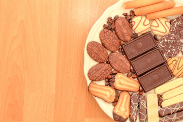 Various chocolate cakes on the table. Plate with completely vegan christmas bisquits, baked of wholemeal flour.