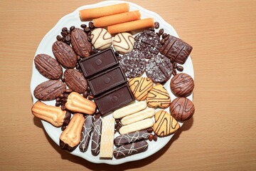 Various chocolate cakes on the table. Plate with completely vegan christmas bisquits, baked of wholemeal flour.