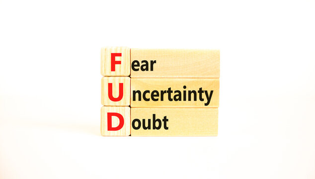 FUD fear uncertainty doubt symbol. Concept words FUD fear uncertainty doubt on wooden blocks on a beautiful white table white background. Business and FUD fear uncertainty doubt concept. Copy space.