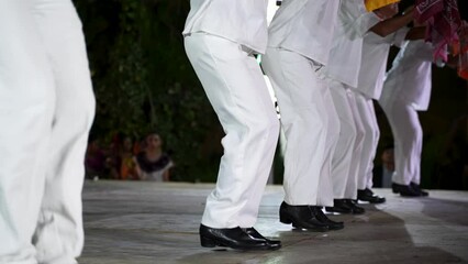 Closeup of men and women dancing a Mexican cultural folk dance sharing the different ethnic dances of the Yucatan in Merida in slow motion.