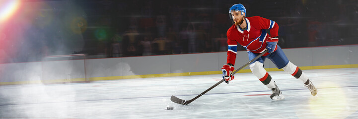 Man, professional hockey player in motion, playing, training over ice rink. Stickhandling activity....