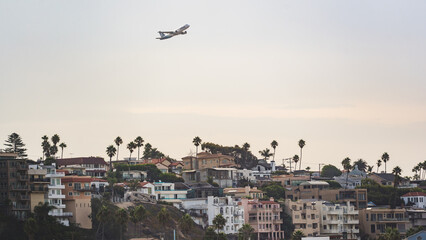 airplane taking off over city