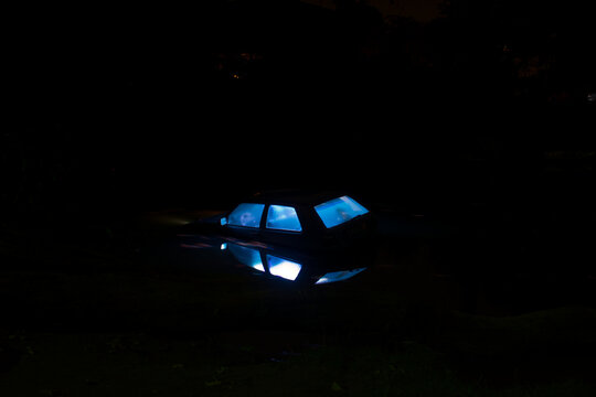 Light art with illuminated Car in river