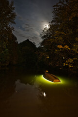 illuminated boat at the river - light art