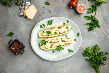 Zucchini stuffed with minced meat and cheese on a light background. Restaurant menu, dieting, cookbook recipe top view