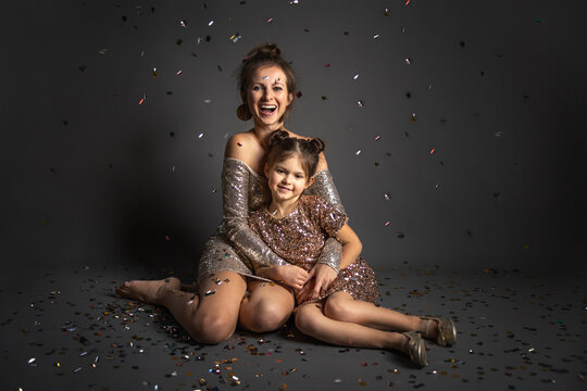 Mother and doughter celebrate New Years with the confetti rain.