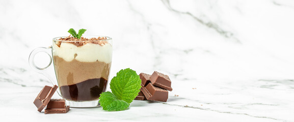 dessert three chocolates pudding decorated with mint on a light background. Layered delicious...