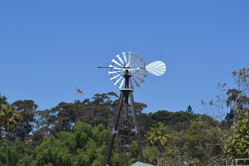 Traditional windmill in a farm with blue sky background
