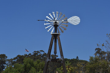 Traditional windmill in a farm with blue sky background