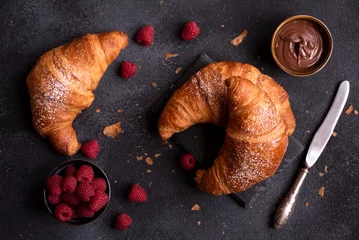 Tuinposter Delicious sweet croissant with fresh fruit and chocolate on dark background © Maresol