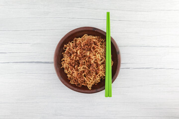 instant fried noodles. Served on earthenware plates made of clay. white background. From above.