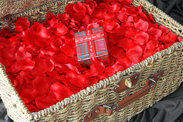 all my love written on a ribbon wrapped around a special gift resting bon rose petals in a wicker...