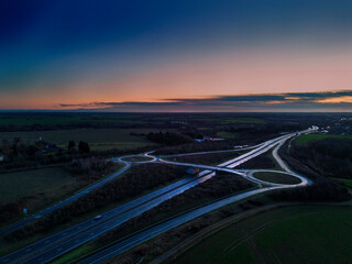 An aerial view of a junction on the A14 trunk road at dawn in Suffolk, UK