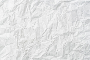Wrinkled or crumpled white stencil paper or tissue after use with large copy space used for background texture in decorative art work