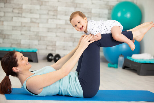 pregnant woman doing sport with her baby