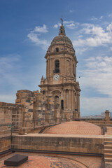 Fototapeta premium Panorama of Malaga city center and seaport from the roof of La Manquita Cathedral. La Manquita Cathedral roof tour. Amazing view, blue sky above. Andalusia, Spain
