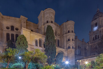 Naklejka premium Amazing night photography around Malaga La Manquita Cathedral, Plaza de la Constitucion and Marques de Larios street in long time exposure. Malaga old city center empty streets at night. Spain