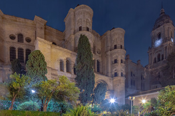 Naklejka premium Amazing night photography around Malaga La Manquita Cathedral, Plaza de la Constitucion and Marques de Larios street in long time exposure. Malaga old city center empty streets at night. Spain