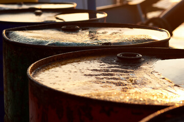 Fragment of old fuel barrels at sunrise