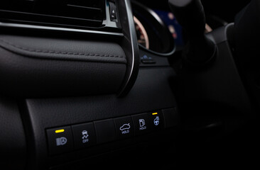 Car buttons on a control panel background, car elements close view