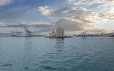 . Amazing scenic view of the marina and the seaport of Malaga in the rays of the sun. Emerald sea,...