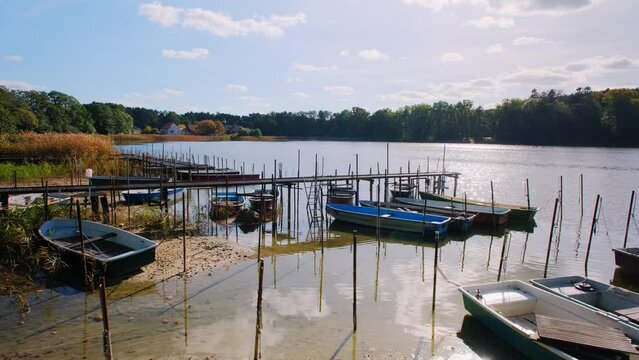 Small fishing boats anchored on the shore of the lake. Fishing harbor.