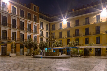 Amazing night photography around Malaga La Manquita Cathedral, Plaza de la Constitucion and Marques de Larios street in long time exposure. Malaga old city center empty streets at night. Spain