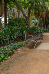 Parque de Malaga, Jardin Subtropical, Malaga botanical garden with old wooden benches for walkers. Andalusia, Spain