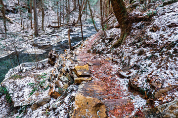 Hiking the Fiery Gizzard trail by a mountain creek with a winter scene. In South Cumberland State Park, Tracy City, Tennessee USA.