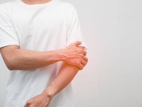 Male employee elbow pain from hard working office syndrome