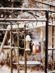 Swedish red bird feeders in the winter. swedish red houses.