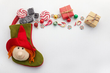 Befana sock with sweet coal and candy on white background. Italian Epiphany day tradition.