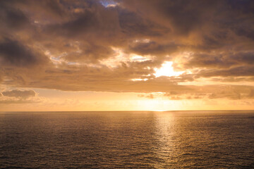 Naklejka na ściany i meble Sunset over the ocean at Madeira island in Portugal
