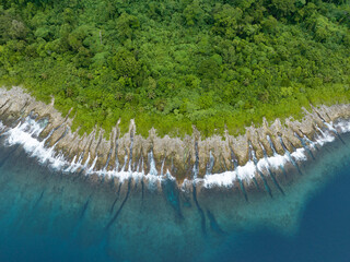Spur and groove channels have eroded on the edge of a remote island in the Solomon Islands. This...