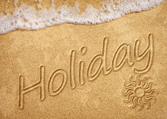 Word Holiday written on white sand beach. Summer holiday, travel and vacation concept. Abstract sea beach background