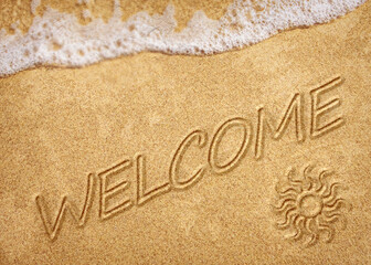 Word Welcome on beach - concept holiday background